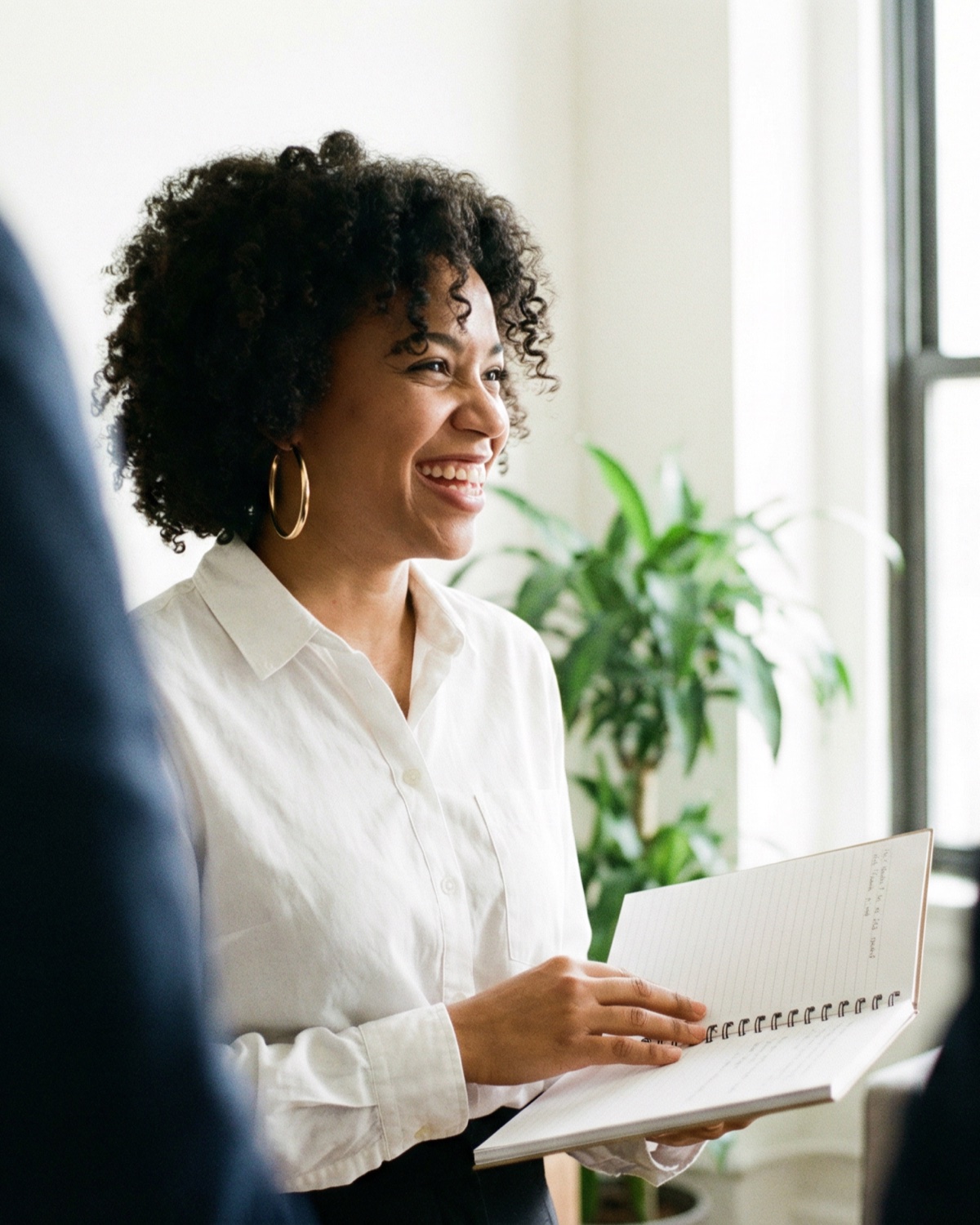 Healthcare advisor smiling while leading a team discussion